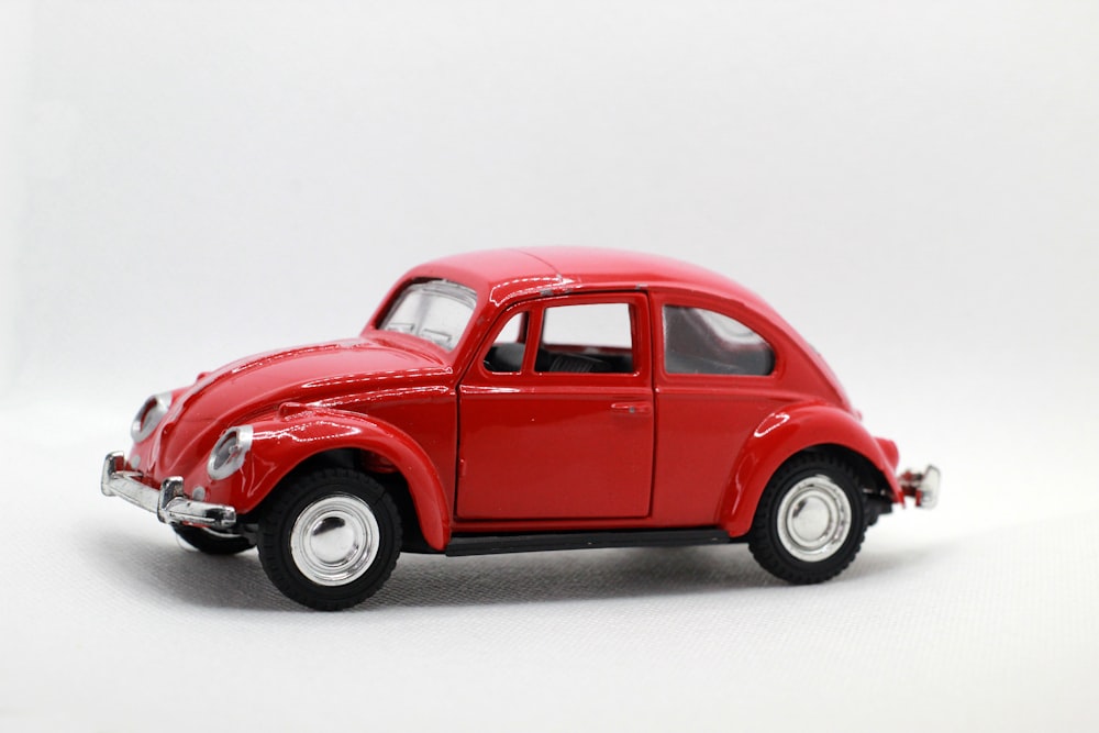 a red toy car on a white background