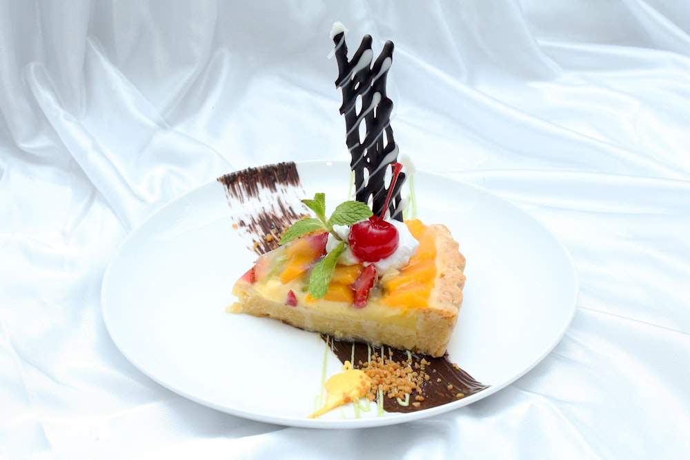 a piece of pie with fruit and chocolate on a white plate