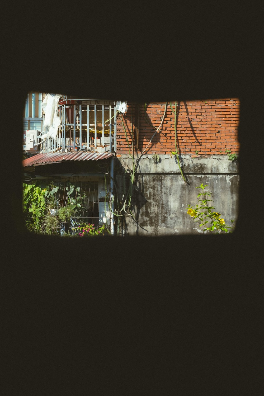 a view of a building through a hole in a wall