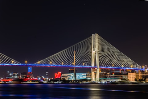 a large bridge over a body of water at night