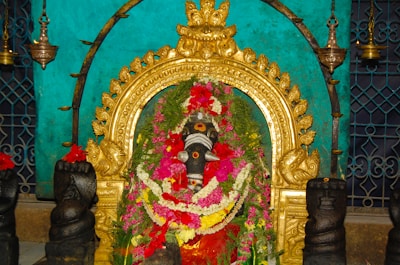 Front view of Maa Kamakhya temple adorned with marigold garlands during morning aarti.
