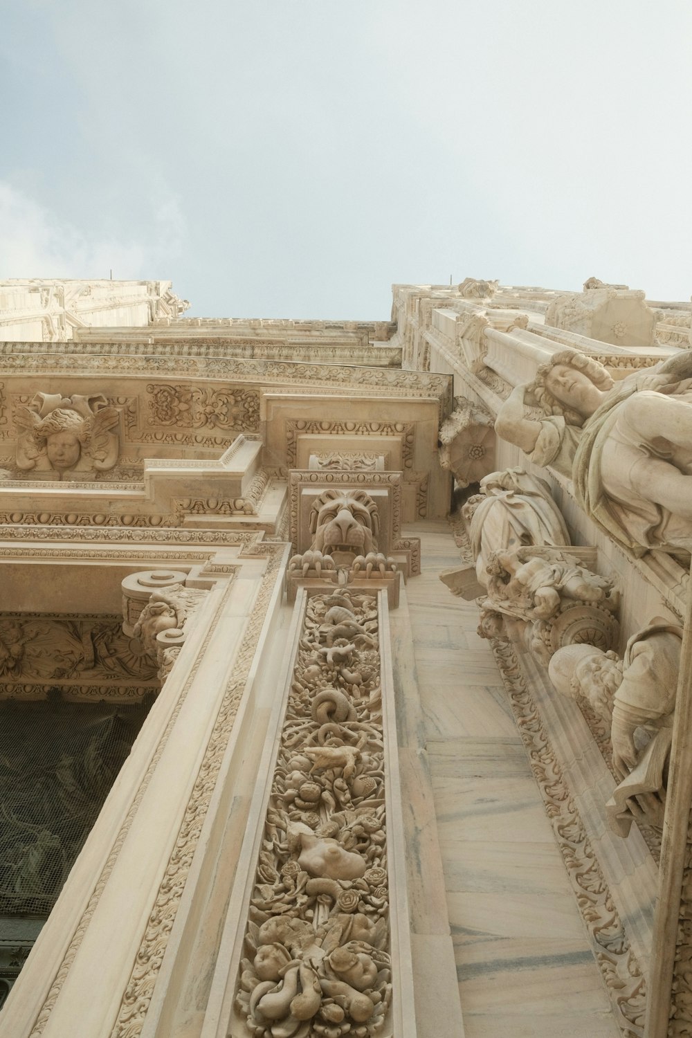 a close up of a building with statues on it