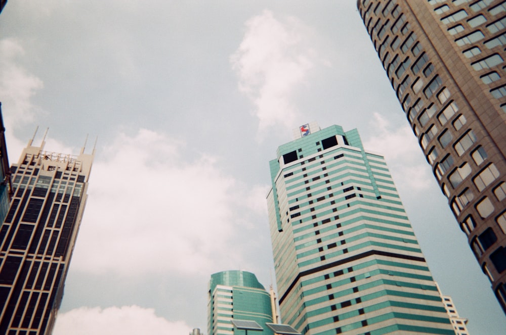 a couple of tall buildings sitting next to each other