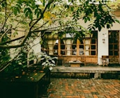 An inviting outdoor patio surrounded by lush greenery and traditional architecture.