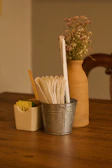 Elegant sugarcane packaging displayed on rustic wooden table.