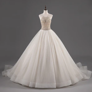 An elegant girls' party dress in ivory with subtle shimmer and floral embroidery, displayed on a mannequin.