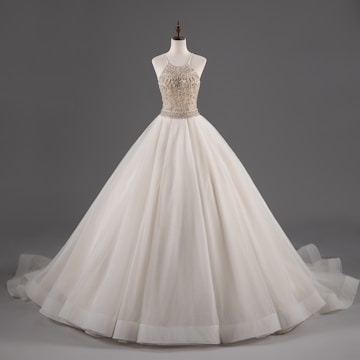 Elegant custom-made dress displayed on a mannequin.