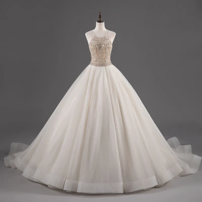 Elegant evening dress with delicate embroidery displayed on a mannequin in soft lighting