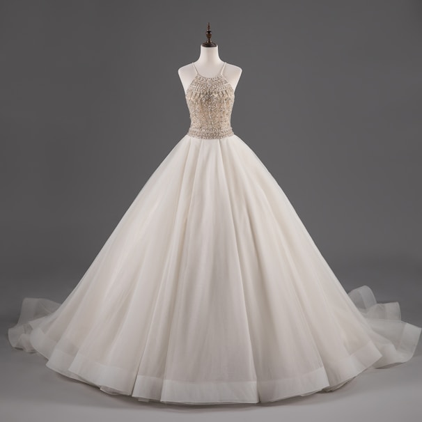 Elegant quinceañera dress displayed on a mannequin with sparkling lights