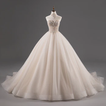 Luxurious ball gown with full skirt and delicate details, set against a light, premium background.