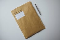 a brown envelope with a pen on top of it