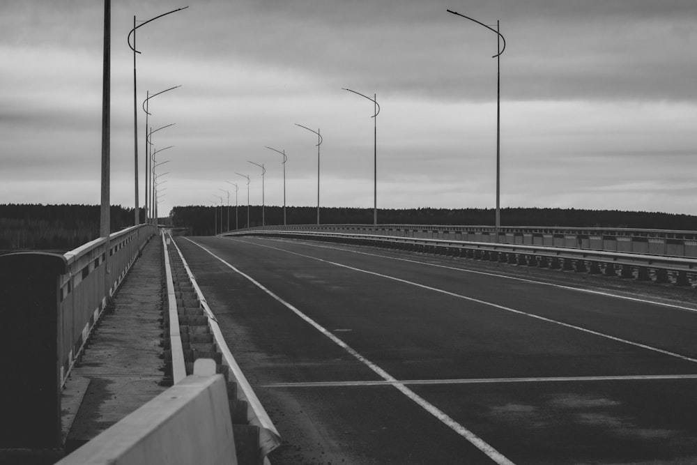 a black and white photo of an empty highway