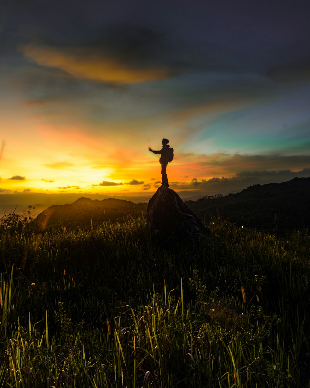 a person standing on top of a lush green field