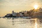 A scenic coastal town featured in a beloved movie, bathed in golden hour light.