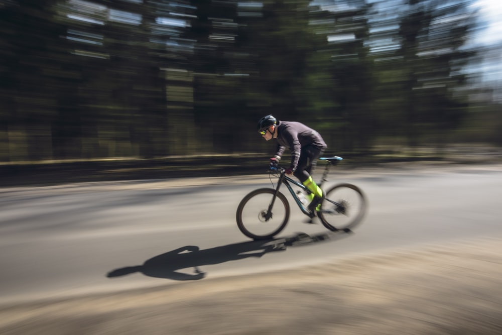 a man riding a bike down a street