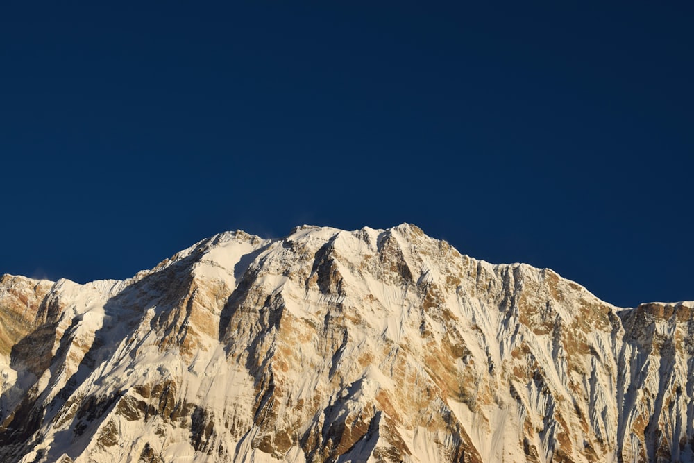 a snow covered mountain with a clear blue sky