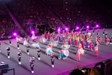 Wide shot of the Vatan Chorus performing on stage with traditional costumes.