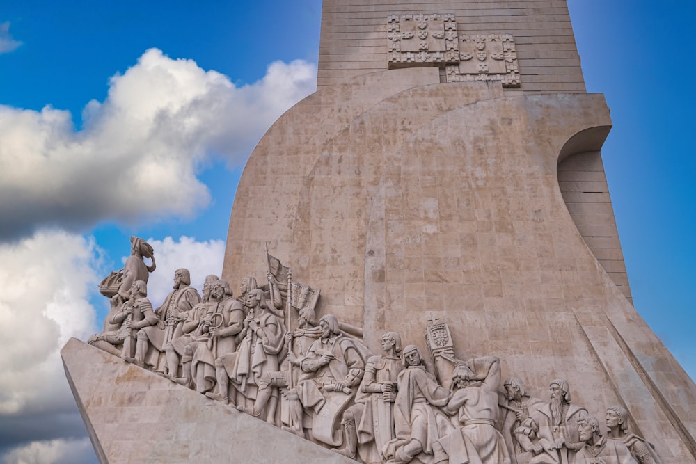 a monument with statues of people on it