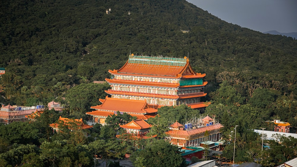 a tall building sitting on top of a lush green hillside