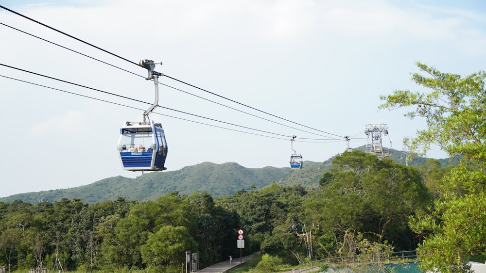 a blue and white ski lift going up a hill