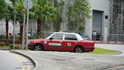A sleek taxi car waiting at a city street corner in Kuwait.