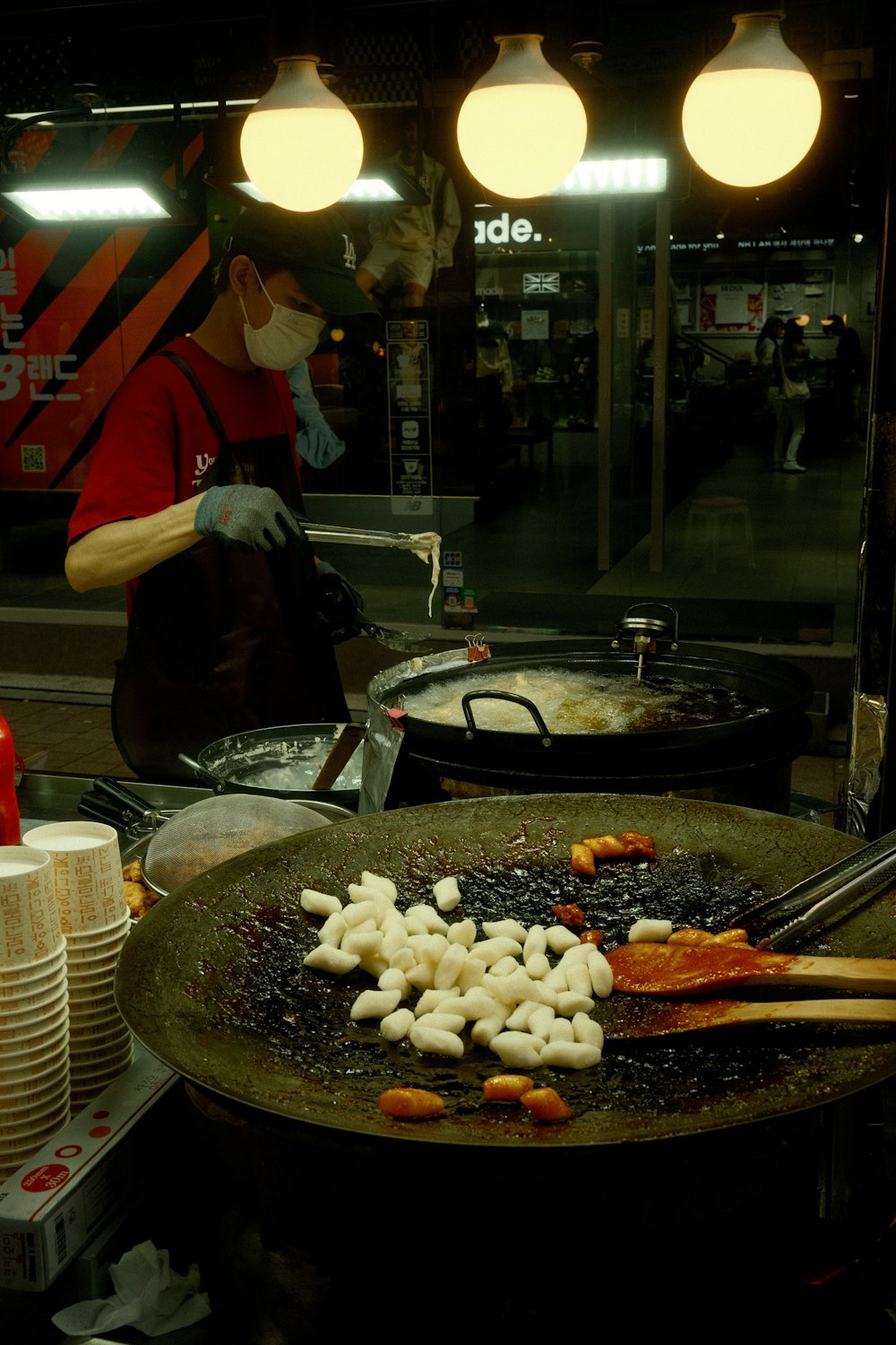 a person cooking food in a frying pan