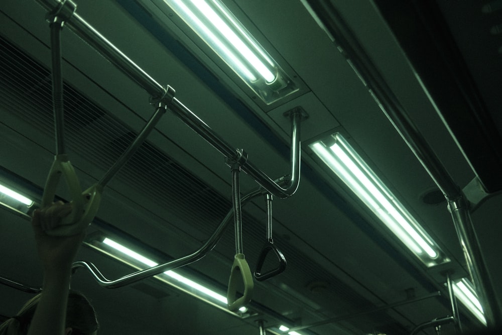 a person holding a cell phone while riding a train