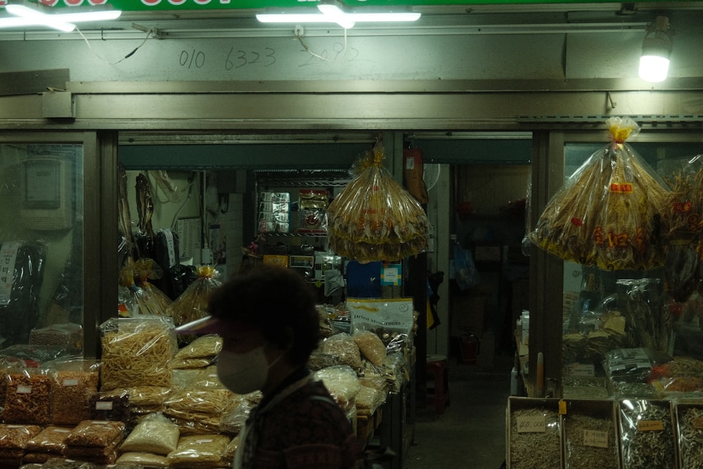 a person wearing a face mask in front of a store