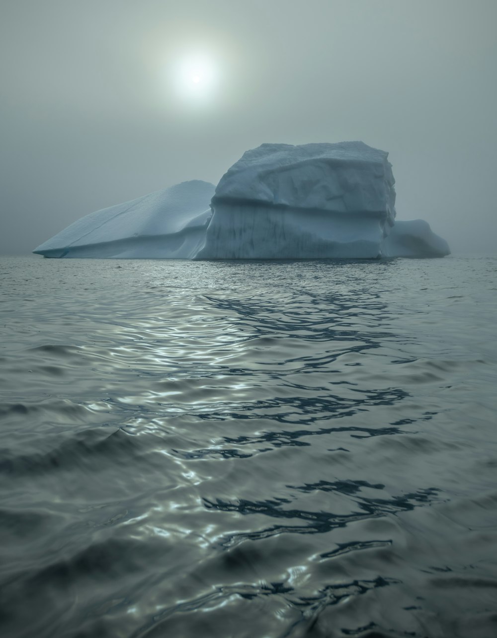 a large iceberg floating in the middle of the ocean