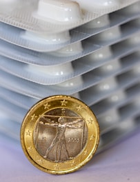 Close-up of a euro coin balanced on a financial chart showing stable inflation trends.
