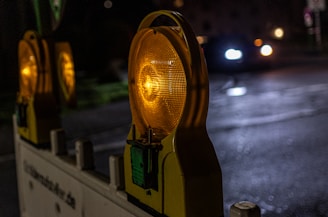 Nighttime vehicle recovery with bright safety lights illuminating the scene on a rural road.