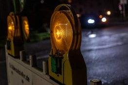 Retro-reflective road safety signs installed along an expressway at dusk.