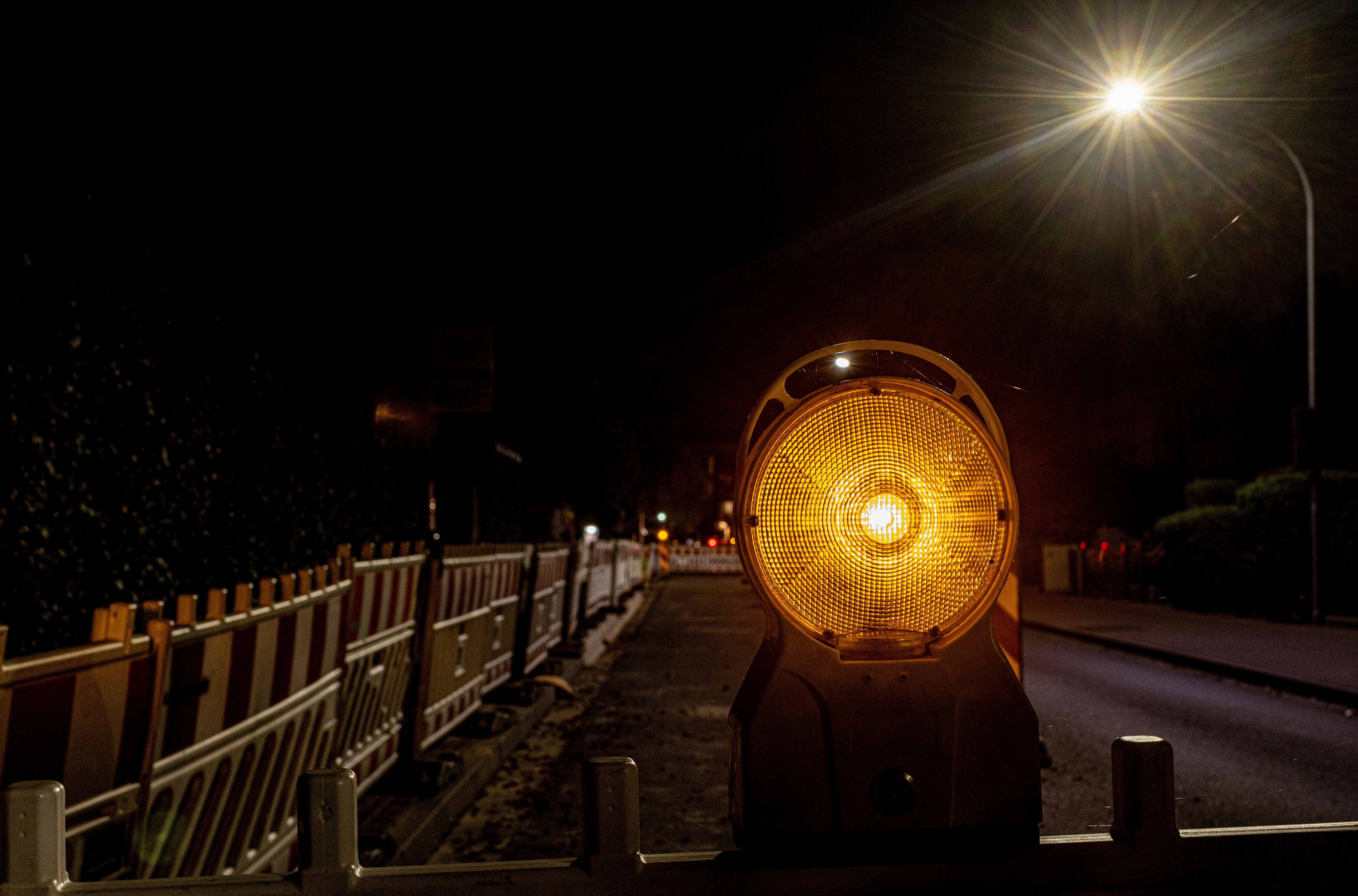 a street light sitting on the side of a road