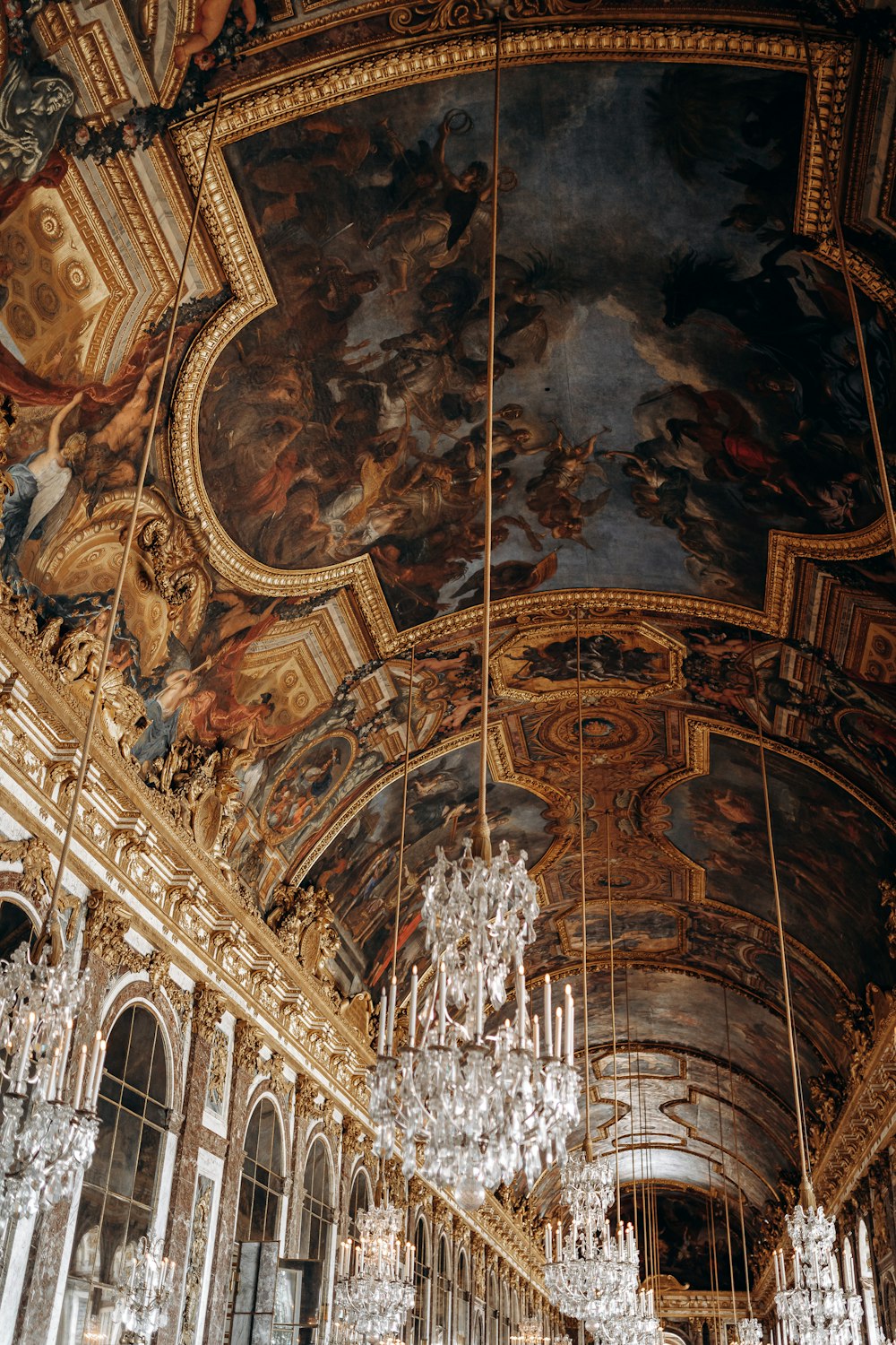 a large room with chandeliers and paintings on the ceiling