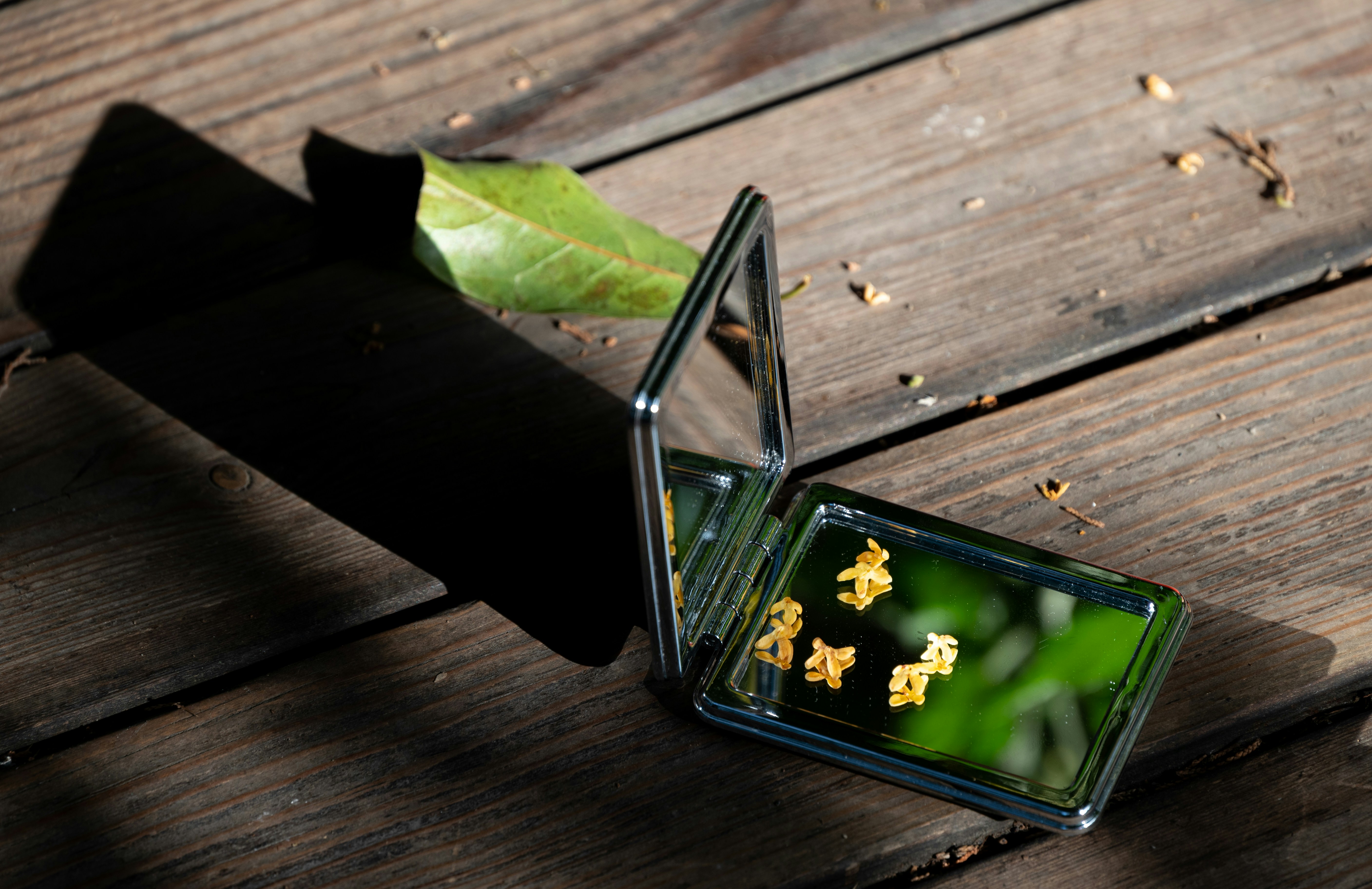 a glass box with gold flakes in it sitting on a wooden table
