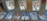 A collection of framed and unframed portrait photographs displayed on a glass surface, primarily featuring young adults in formal attire, likely school or graduation photos. The images show individuals wearing white shirts and dark ties, suggesting a uniform or dress code.