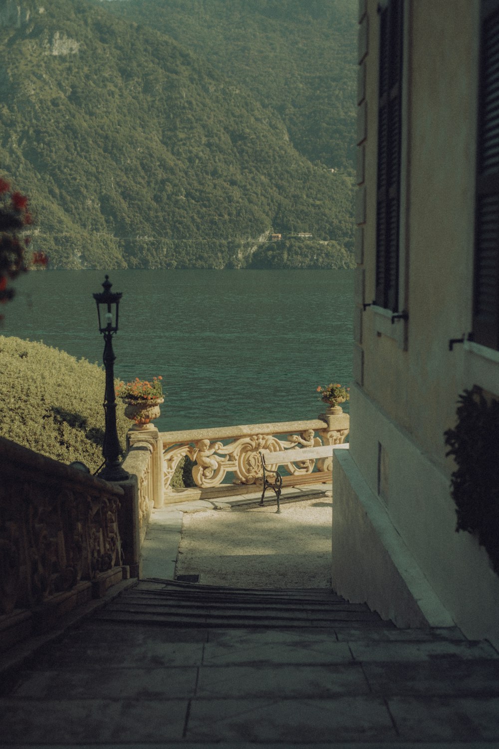an open door leading to a balcony overlooking a body of water