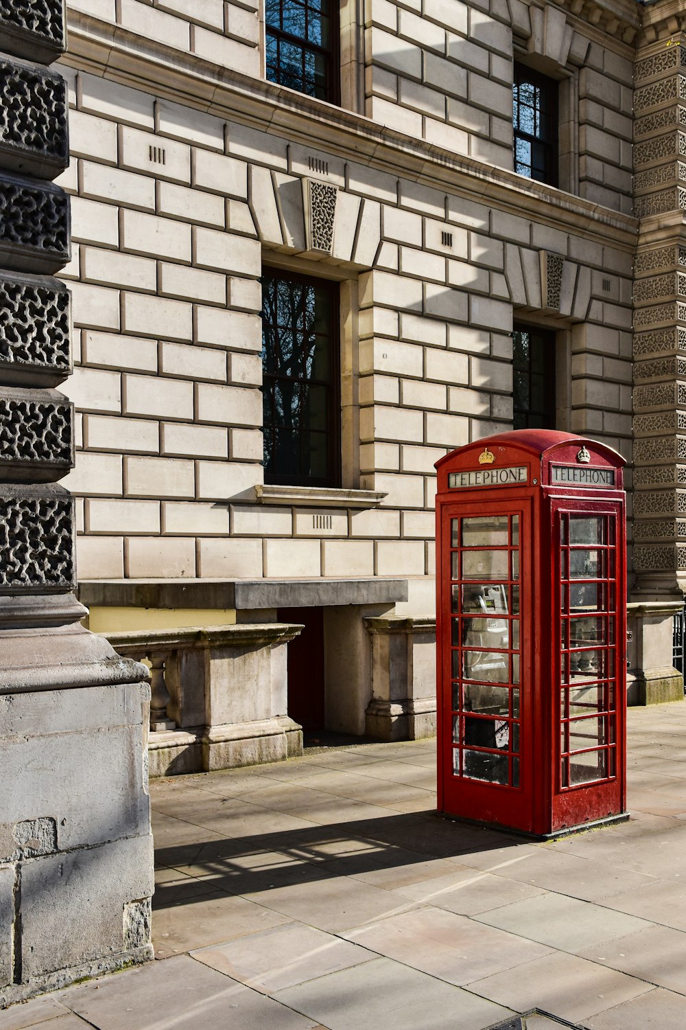 a red phone booth in front of a building