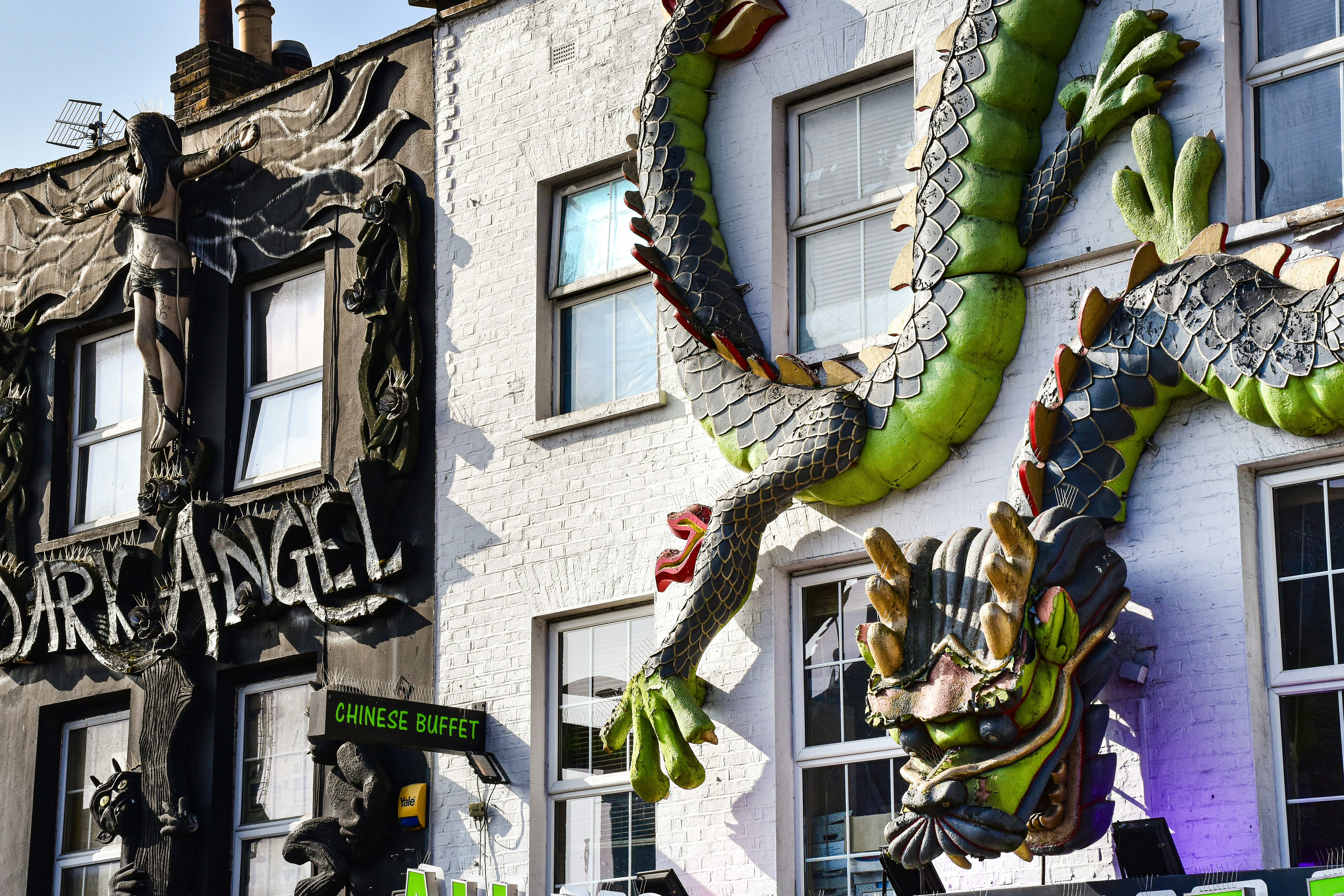 a building with a dragon sculpture on the side of it