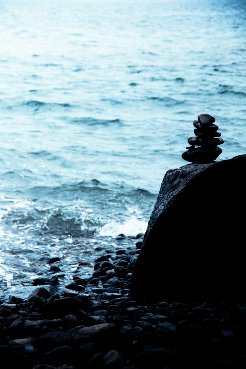 a stack of rocks sitting on top of a rocky beach