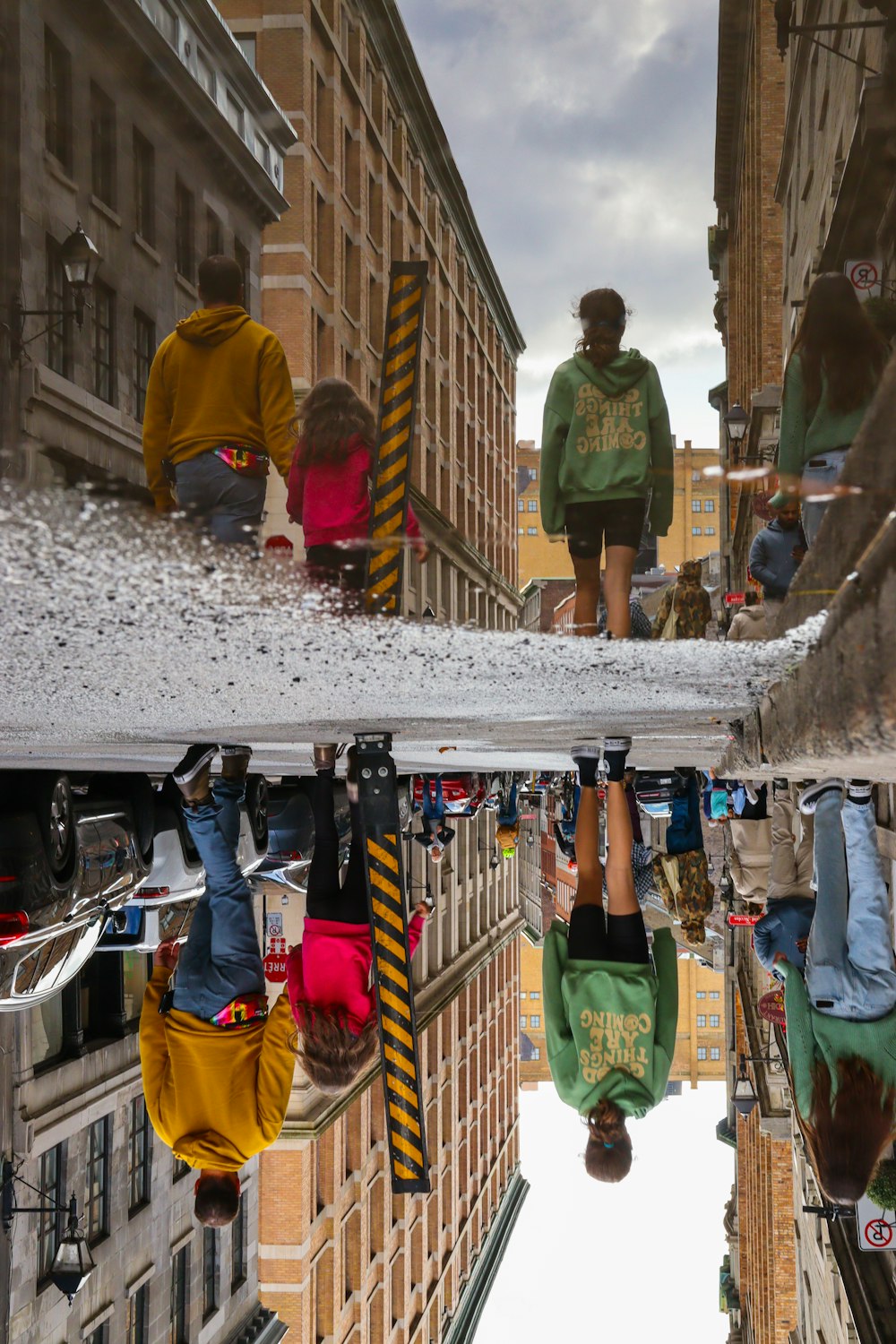 a reflection of a person hanging upside down in a puddle