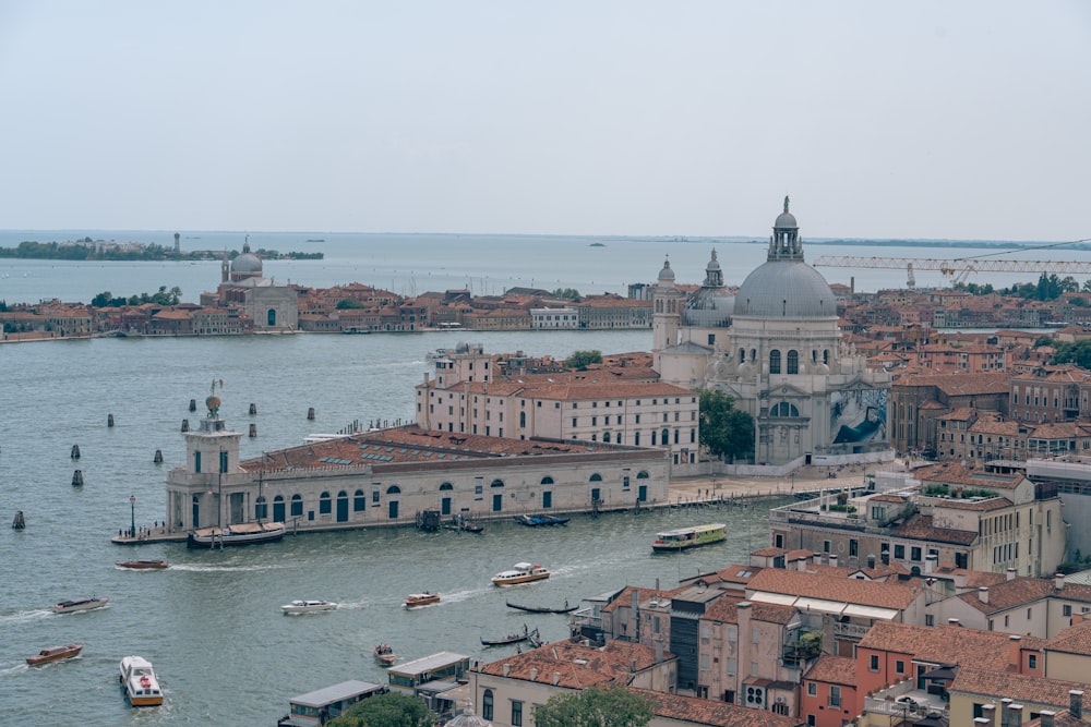 an aerial view of a city with boats in the water