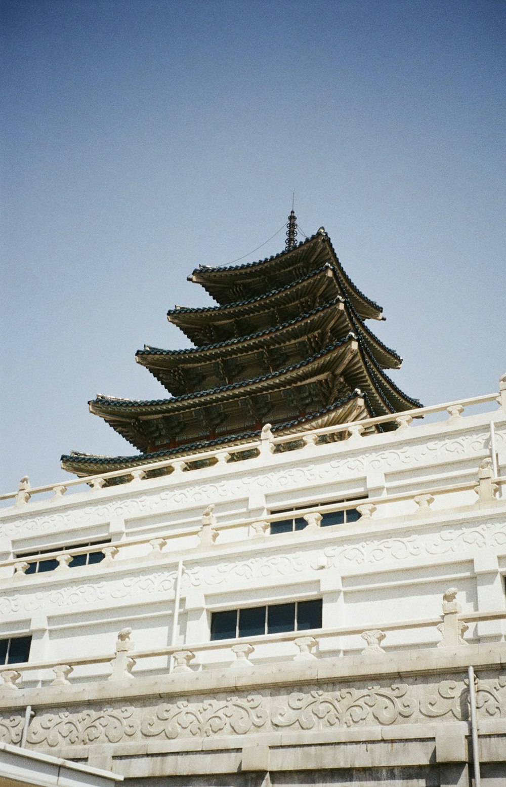 a tall white building with a clock on it's side