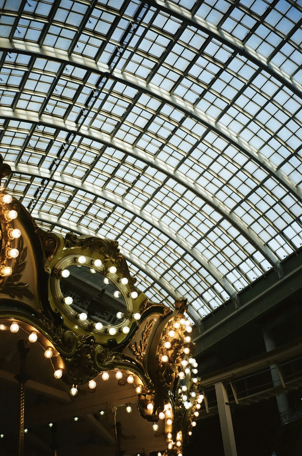 a large clock hanging from the ceiling of a building