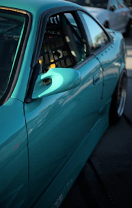 a blue car parked on the side of the road
