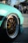 A happy customer standing next to her car with new aluminum wheels.