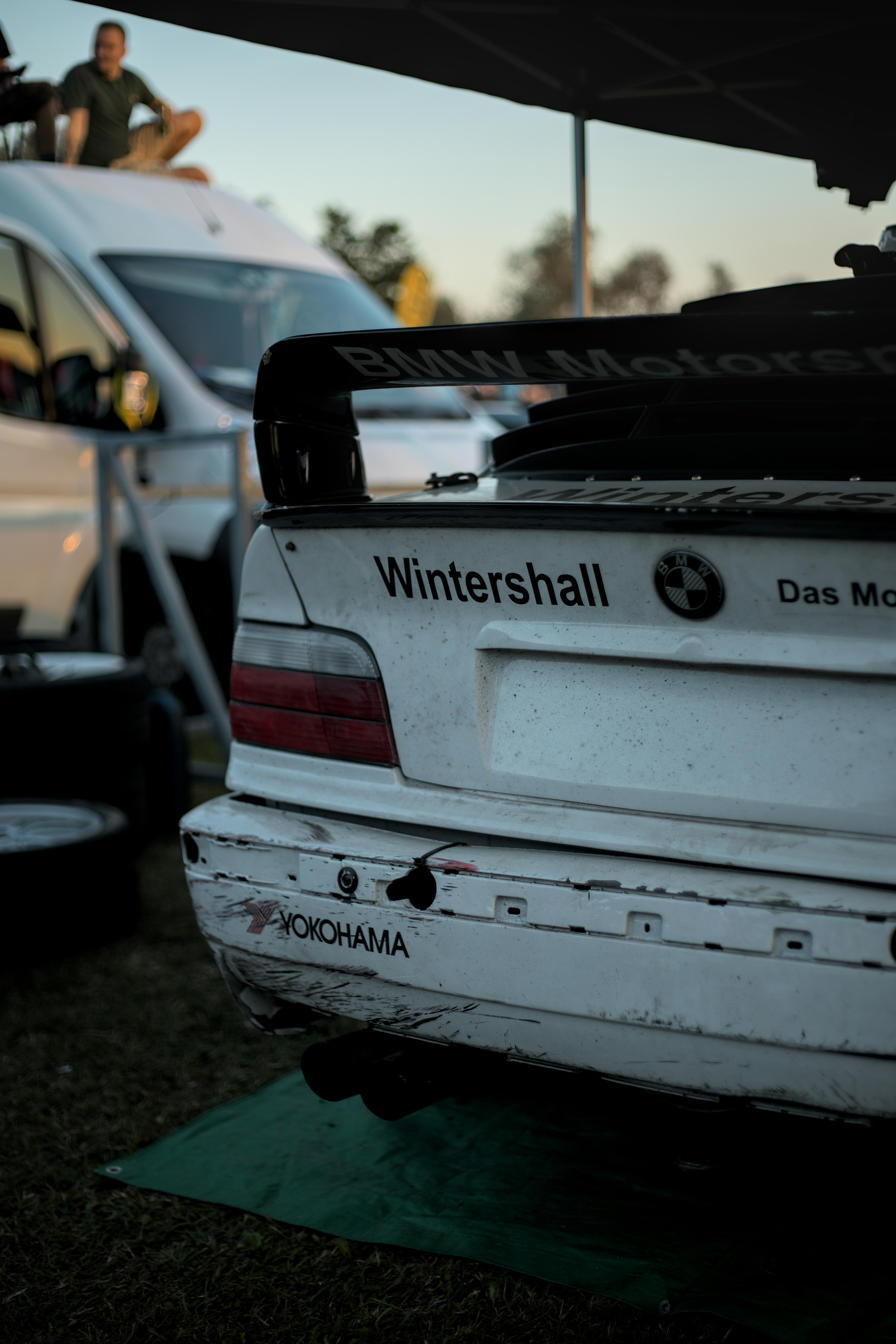 a white car parked next to a white van