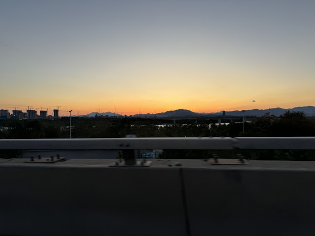 A simple construction barrier with a soft sunset background, symbolizing progress and anticipation.
