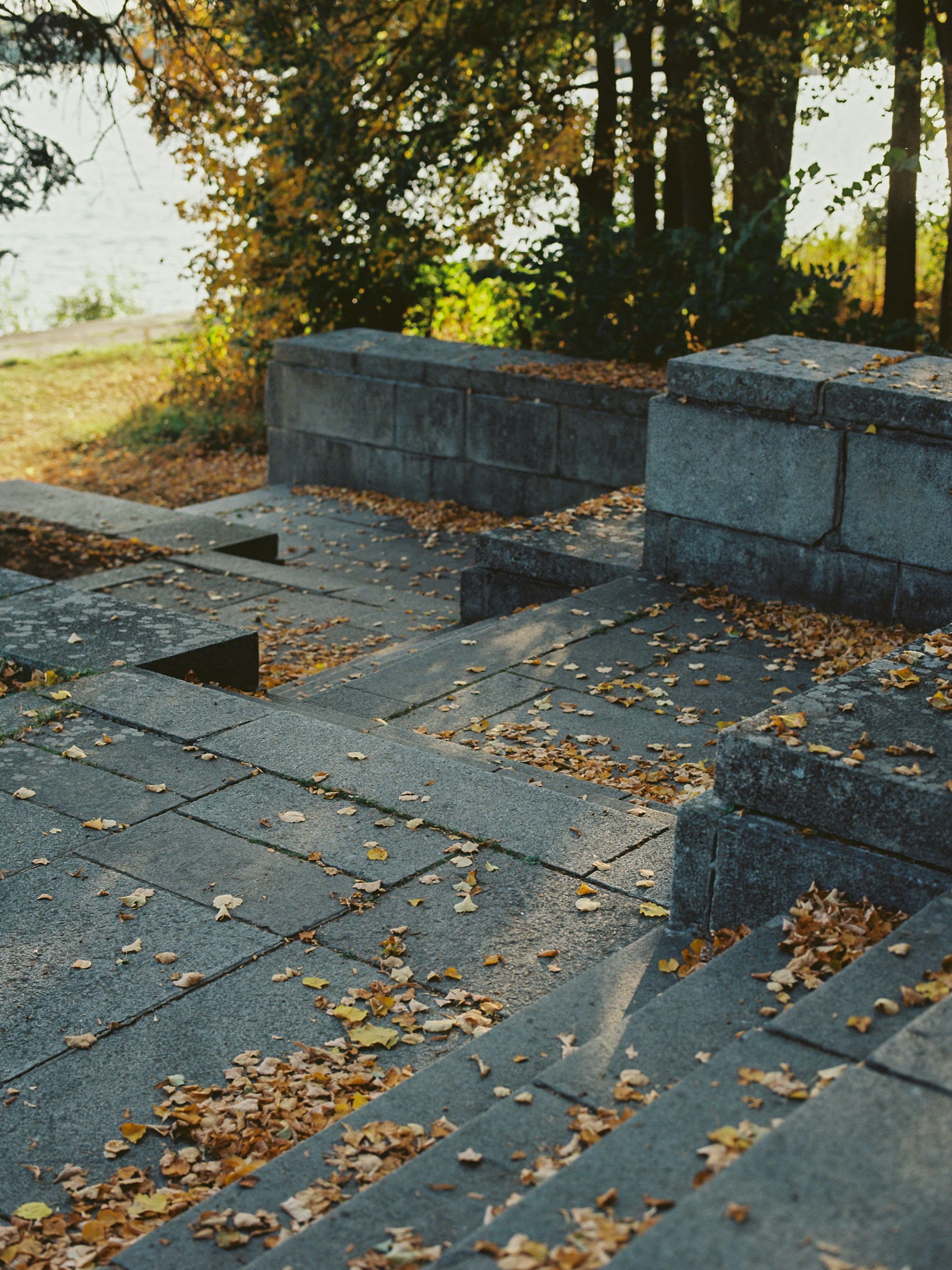 a couple of cement benches sitting on top of a field
