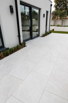 Exterior view of a home showing perfectly installed sliding doors letting in sunlight.